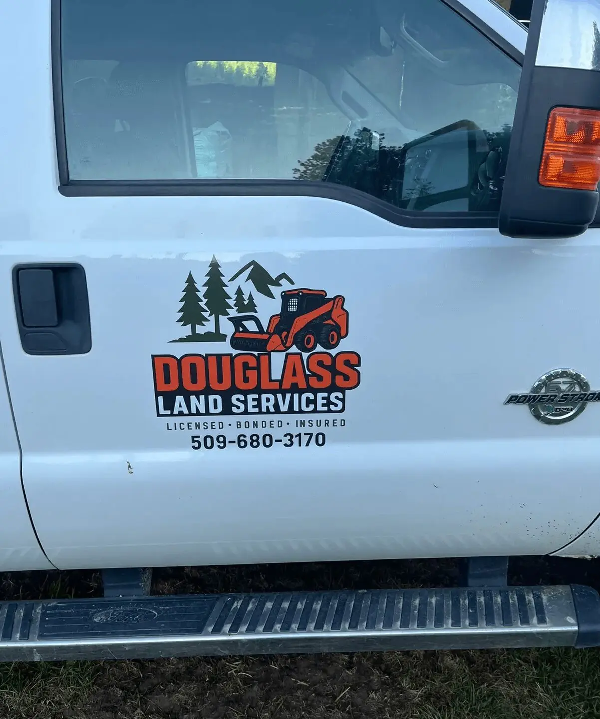 Truck with Douglass Land Services logo.